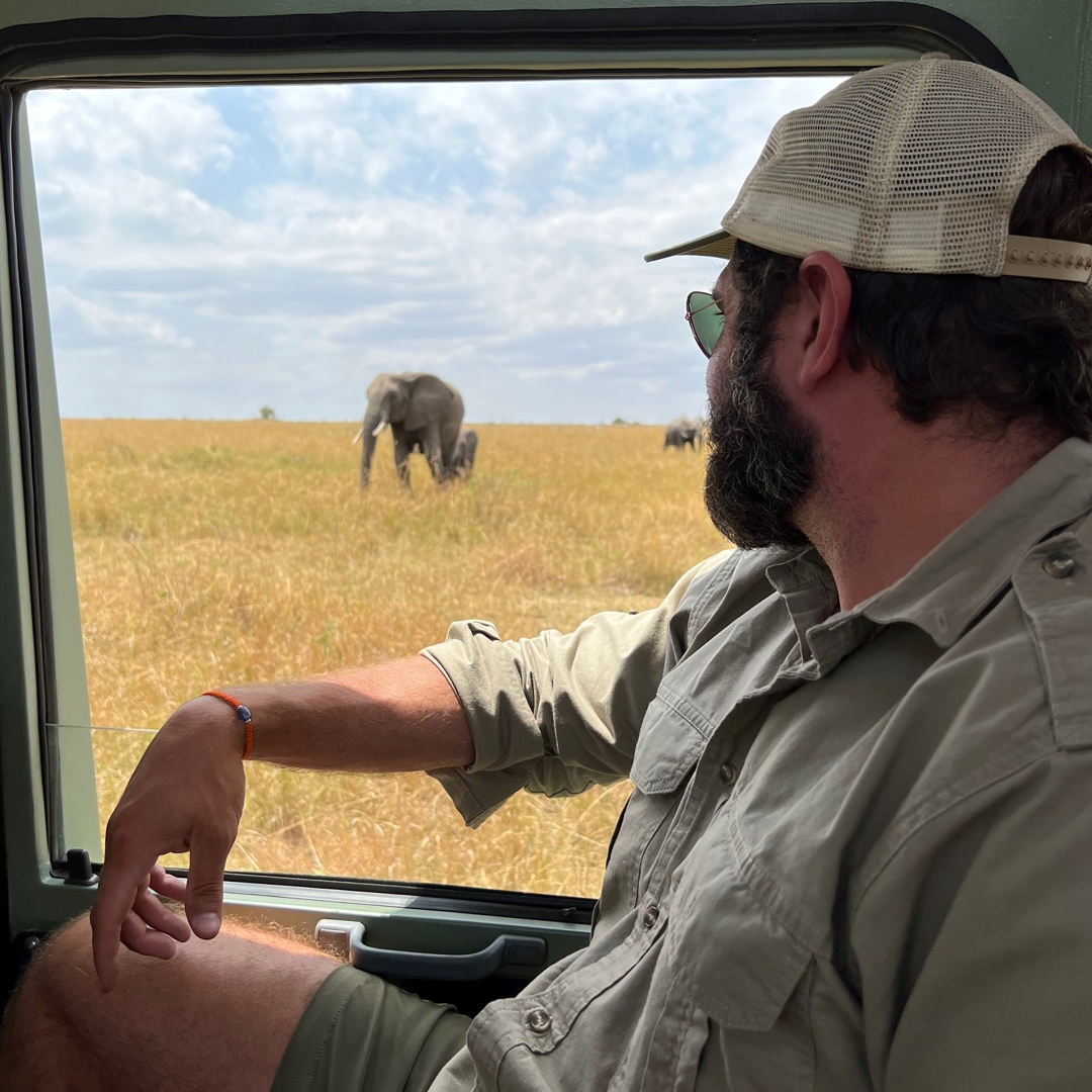Man on safari looking at elephant 